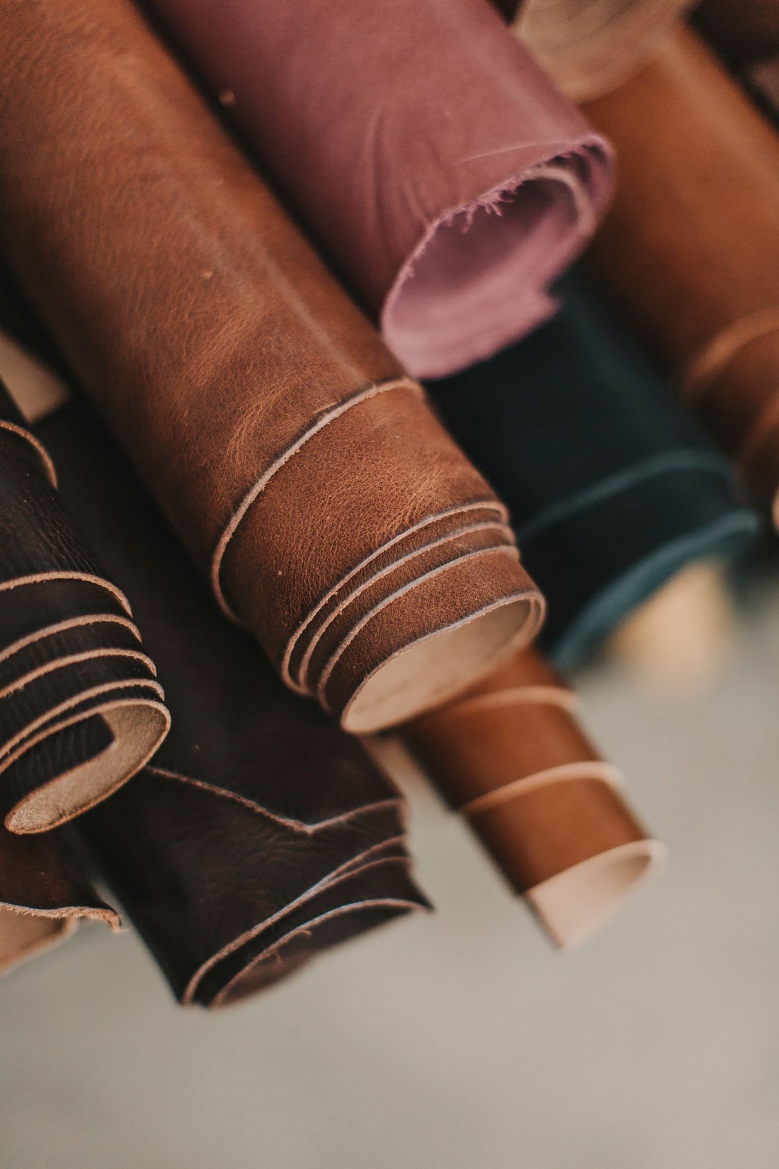 Rolled hides of tanned leather stacked together.